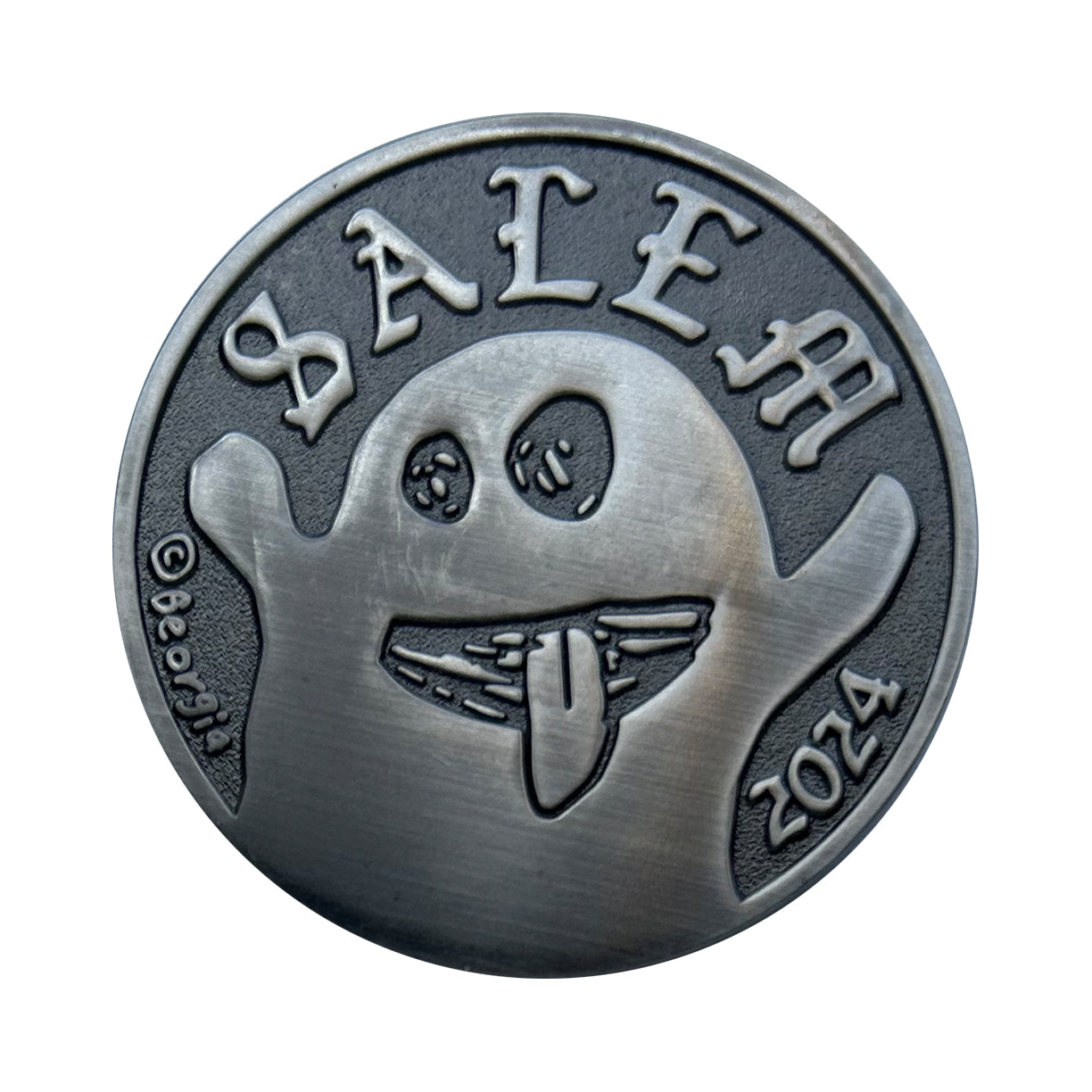 collectible coin with ghost and Salem on it.