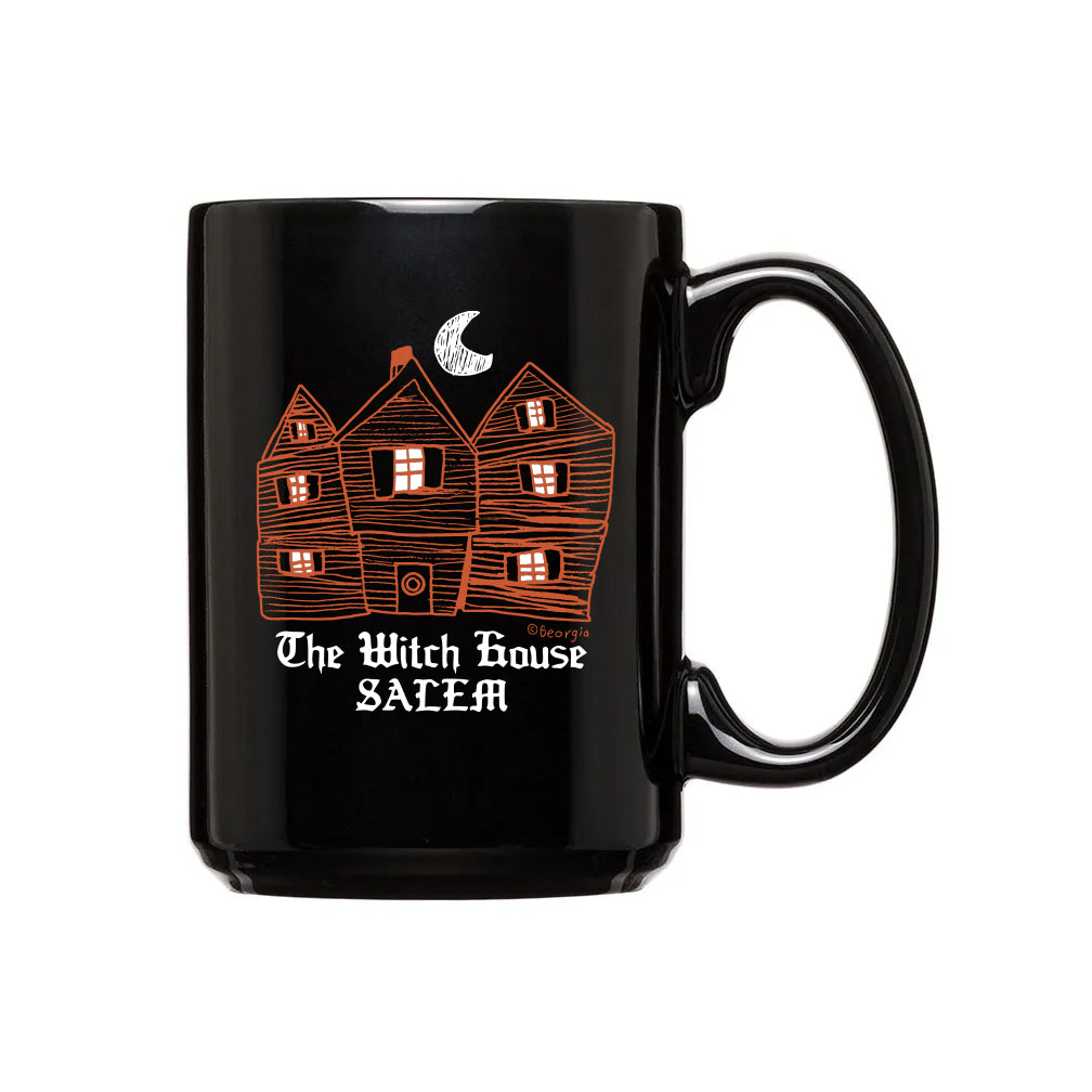 Black 15 oz mug with the witch house on it orange drawing white text